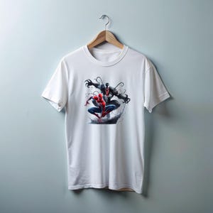 May include: White t-shirt with a graphic print of Spider-Man and Venom in a battle pose.