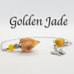 May include: Golden Jade crystal pendulum with a silver chain and a butterfly charm. The pendulum has a yellow crystal bead and a clear crystal with orange and brown inclusions.
