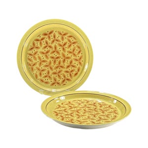 May include: Two yellow ceramic plates with a floral pattern. The plates have a light yellow background with a repeating pattern of brown flower-like shapes. A thin brown line borders the edge of each plate.
