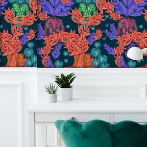May include: Wallpaper featuring a repeating pattern of stylized botanical elements and jackets in shades of red, purple, teal, and green against a dark teal background. The design includes large leaves and floral shapes, creating a vibrant and artistic aesthetic.