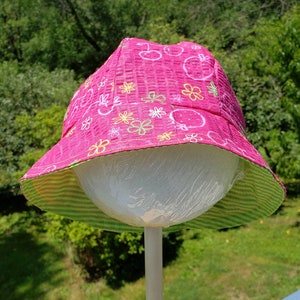 Pink strawberry and cherry bucket hat with reverse green stripe hat