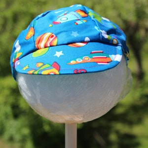 Reversible cotton cap with blue and rocket ships
