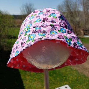 Reversible cotton bucket hat for newborn with polka dots on oneside and lady bugs and flowers