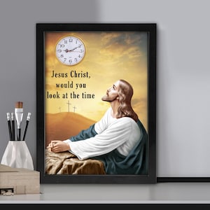 May include: Framed art print featuring an image of Jesus looking up at a clock. The text reads "Jesus Christ, would you look at the time." The artwork has a black frame and a warm, golden background.