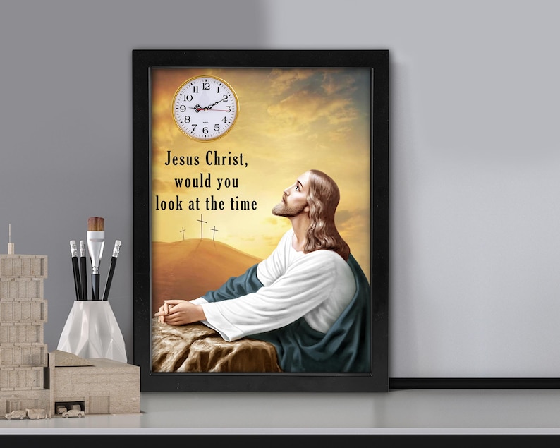 May include: Framed art print featuring an image of Jesus looking up at a clock. The text reads "Jesus Christ, would you look at the time." The artwork has a black frame and a warm, golden background.