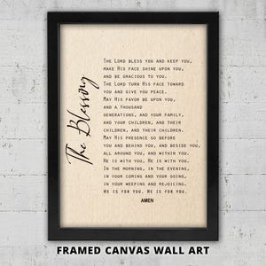May include: Framed canvas wall art featuring a religious text, "The Blessing," in black script. The text is printed on a beige background and framed in a black border. The words "FRAMED CANVAS WALL ART" are printed at the bottom.