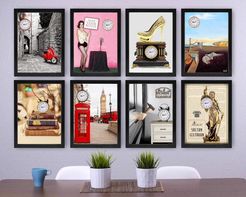 May include: A collection of framed art prints featuring clocks and various themes. The prints include a red scooter in an alley, a woman with a sign, a gold high heel, a surrealist painting, a stack of books, a red phone booth, a hammer, and a statue.
