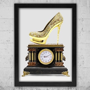 May include: A framed print featuring a gold high-heeled shoe covered in sparkling embellishments atop a vintage clock. The clock has a round face with Roman numerals and ornate detailing. The frame is black.