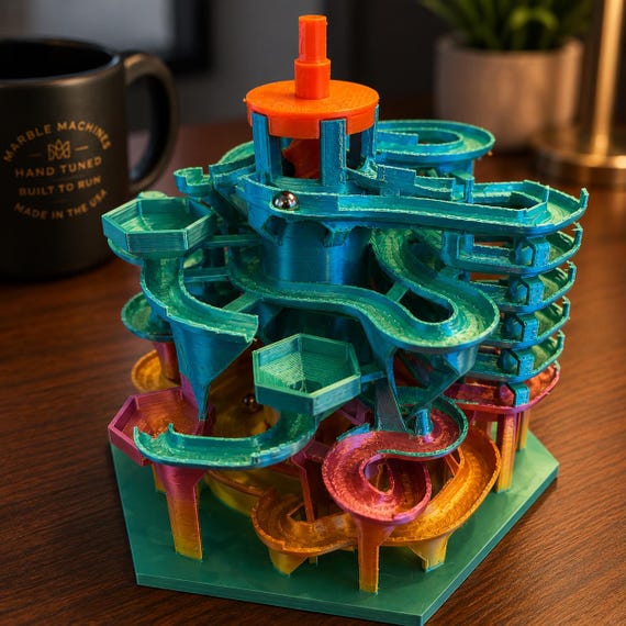 A 3D-printed kinetic marble run machine that loops marbles endlessly on your desk — 1,265 favorites don't lie, this thing is hypnotic.