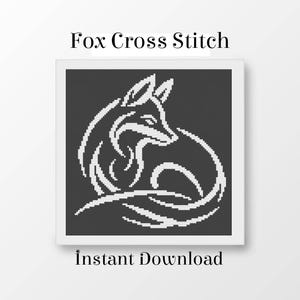 May include: A square cross stitch pattern featuring a white fox silhouette on a dark gray background. The text Fox Cross Stitch is displayed above the image, and the text Instant Download is positioned below the graphic design.