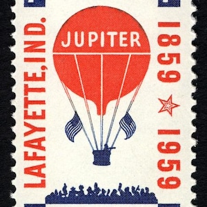 May include: A vintage 7-cent Air Mail stamp from the U.S.A. featuring a red hot air balloon with the word "JUPITER" and two American flags. The stamp commemorates the 1859-1959 Lafayette, Ind. event.