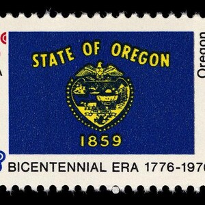 May include: A vintage postage stamp featuring the Oregon state flag. The stamp has a blue background with the state seal in the center, and the text "STATE OF OREGON" in yellow. The stamp also includes the text "1859" and "BICENTENNIAL ERA 1776-1976".