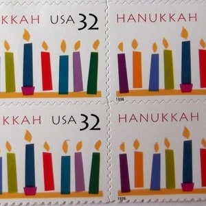 May include: A sheet of four Hanukkah stamps. Each stamp features a menorah with nine colorful candles and the text "HANUKKAH USA 32". The year "1996" is printed at the bottom of each stamp.