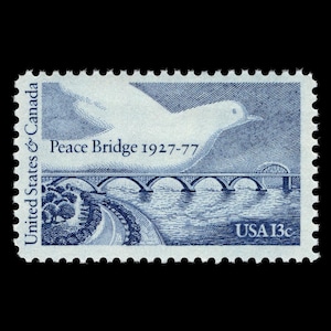 May include: A blue and white stamp depicting a bridge with the text "Peace Bridge 1927-77" and "USA 13c".