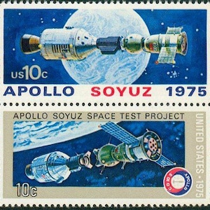 May include: Two United States postage stamps featuring the Apollo-Soyuz Test Project. The top stamp shows a spacecraft against a blue background with a planet. The bottom stamp shows a different view of the spacecraft with a solar panel. Text includes "APOLLO SOYUZ 1975".