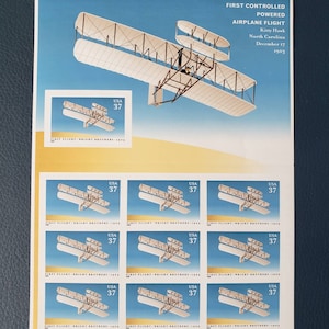 May include: A sheet of nine postage stamps commemorating the first controlled powered airplane flight by the Wright Brothers. Each stamp features a depiction of the Wright Flyer in flight against a blue sky. The stamps are all labelled "USA 37" and "FIRST FLIGHT - WRIGHT BROTHERS - 1903".