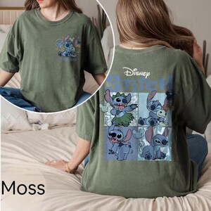 May include: Moss green t-shirt with a Disney Stitch design. The front has a small graphic, while the back features a larger Stitch graphic and the Disney logo. The shirt has a relaxed fit.