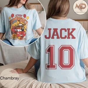 May include: Light blue t-shirt with a red car and the text "It's My Birthday" on the front. The back of the shirt has the name "JACK" and the number "10" in red.