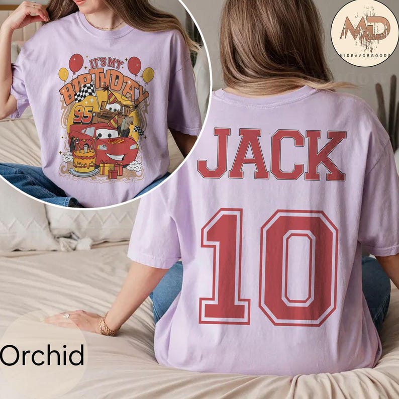 May include: Purple t-shirt with a red number 10 and the name JACK printed on the back. The front of the shirt features a cartoon image of a red race car with the text "It's My Birthday" and the number 95.