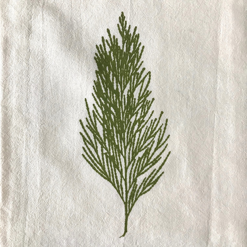 May include: A green leafy branch printed on a white fabric background.