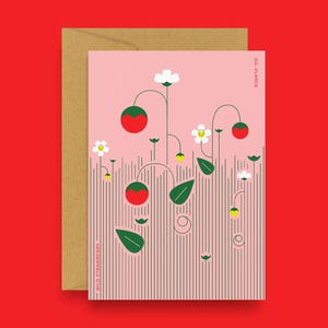 May include: A greeting card with a pink background featuring a stylized illustration of wild strawberries. The design includes red strawberries, white flowers, green leaves, and the text "WILD STRAWBERRY" and "D.C. PLANTS". A brown envelope is behind the card.