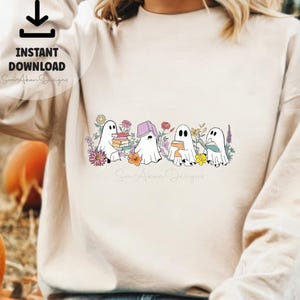 May include: A white sweatshirt with a design of four ghosts reading books surrounded by flowers. The text "Some A-Okay Designs" is at the bottom of the design.
