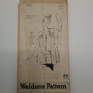May include: Vintage sewing pattern for a maternity smock. The pattern is for a bust size of 34 inches and includes instructions for making an overleaf. The pattern is from Weldons Pattern and is numbered 512.