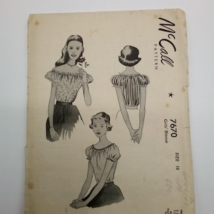 May include: Vintage McCall's sewing pattern for a girl's blouse. The pattern number is 7670, size 10, and the price is 1/3. The pattern is for a blouse with puffed sleeves and a round neckline.
