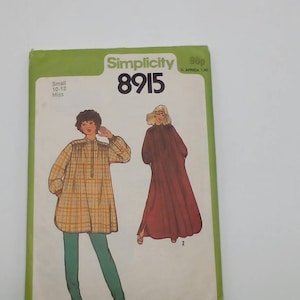 May include: Simplicity sewing pattern number 8915 for a loose-fitting tunic with long sleeves. The pattern is for sizes 10-12 for misses. The pattern shows two different styles of the tunic, one with a plaid print and the other in a solid color.