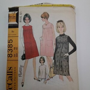 Pode incluir: Padrão de costura vintage McCall's para um vestido de maternidade ou um suéter e uma blusa. O padrão é para o tamanho 16, busto 36. O padrão é impresso em um fundo branco com uma borda amarela. O padrão mostra três estilos diferentes da roupa.