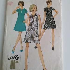 May include: Simplicity sewing pattern number 8702 for a sleeveless dress with a zip fastening. The pattern includes three different dress styles: a blue dress with short sleeves, a floral print dress, and a black and white polka dot dress. The pattern is labelled "Jiffy" and includes instructions for an easy cut and easy sew.
