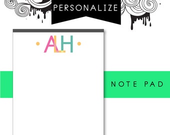 May include: A white notepad with a gray border and a green stripe at the bottom. The notepad has the text "NOTE PAD" on the green stripe. The top of the notepad has the text "PERSONALIZE" in black and the letters "ALH" in pink, yellow, and blue.