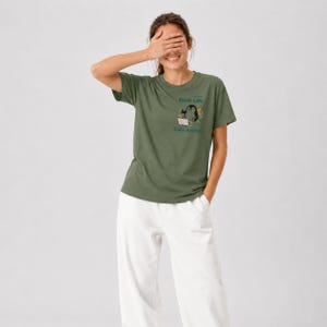 May include: An olive green short-sleeved t-shirt featuring a small graphic on the chest of a penguin using a laptop. The text above the penguin reads Work-Life and the text below reads Data Analyst in a dark teal font colour.