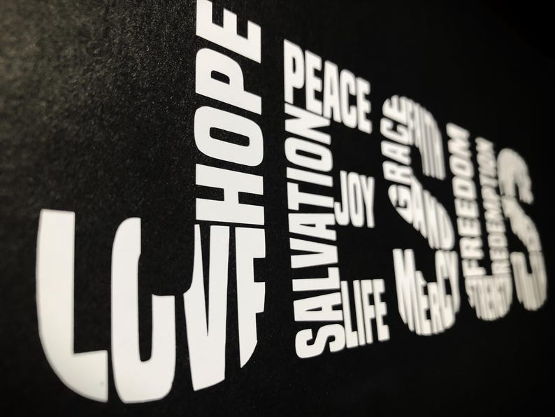 May include: Black background with white text spelling out the words "LOVE", "HOPE", "SALVATION", "PEACE", "JOY", "LIFE", "GRACE", "MERCY", "AND", "FREEDOM", "JESUS".