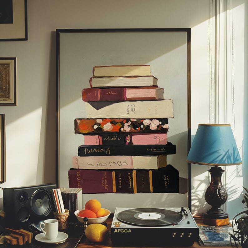 May include: A stack of vintage books with floral and abstract designs on the covers, displayed on a shelf with a record player and a lamp.