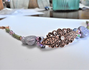 Shangri La ... bracelet, Czech glass ammonite shaped beads, cp filligree link, green, purple ... #945