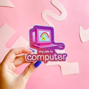 May include: A pink and purple sticker featuring a retro computer design with a rainbow on the screen. The sticker has the text "my job is computer" in a white, rounded font. The background is pink with cut-out shapes.