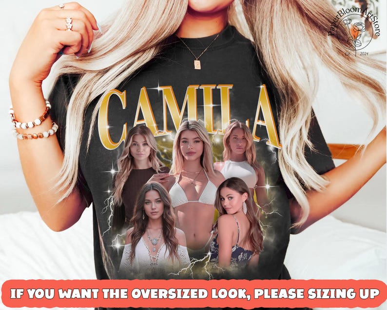 May include: Black t-shirt with the name "CAMILA" in gold lettering. The shirt features a graphic of several women. The text at the bottom reads "IF YOU WANT THE OVERSIZED LOOK, PLEASE SIZING UP".