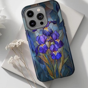 May include: A smartphone case featuring a stained glass pattern of deep blue and purple iris flowers with green stems. The design incorporates dark blue and teal geometric segments that mimic leaded glass, surrounding the camera lens cutout.