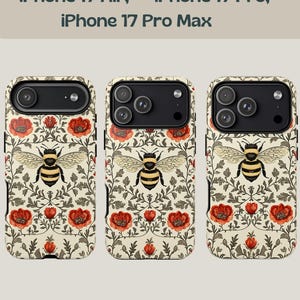 May include: Phone cases with a floral and bee design. The cases are cream-colored with red flowers, green leaves, and a large bee in the center. The text at the top reads "iPhone 17 Air, iPhone 17 Pro, iPhone 17 Pro Max."