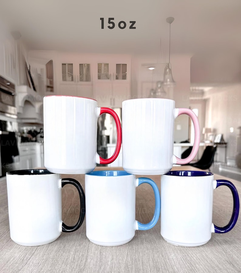 May include: Six white ceramic mugs with colored handles and interior rims. The handles are red, pink, black, blue, and navy. The mugs are labeled "15oz".
