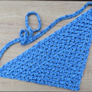 May include: A blue crocheted triangle scarf with a long, thin strap. The scarf is made with a textured stitch and has a light blue and dark blue color pattern.