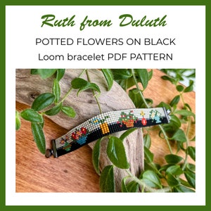May include: A loom bracelet with a black background and colorful potted flowers. The bracelet is made with beads and is on a wooden surface with green leaves.