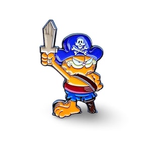 May include: An orange cartoon cat wearing a blue pirate hat with a skull and crossbones design, holding a wooden sword in its right paw. The cat is wearing a red and blue pirate outfit.