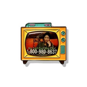 May include: A pin shaped like a vintage television set. The screen displays an image of a woman with the text "You Can't Fool Miss Cleo!" and a phone number. The TV has a yellow frame, green accents, and black feet.