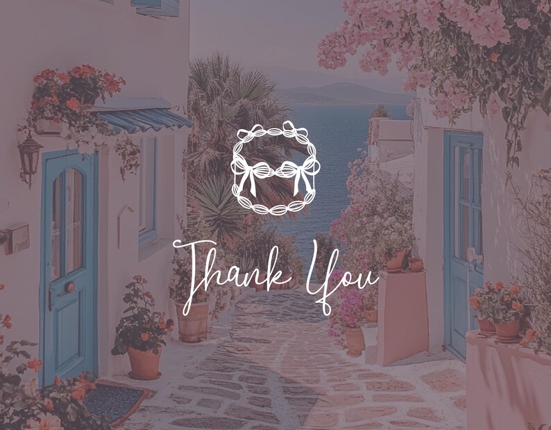 May include: A white wreath with a bow in the centre, with the text "Thank You" written in cursive below it. The wreath is set against a backdrop of a picturesque seaside town with white buildings and pink flowers.