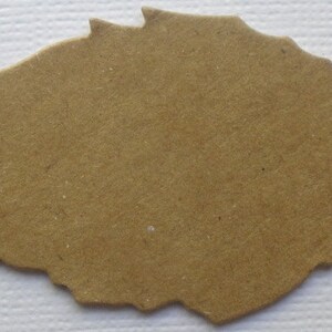 May include: A brown paper leaf cutout, perfect for crafting and scrapbooking projects.