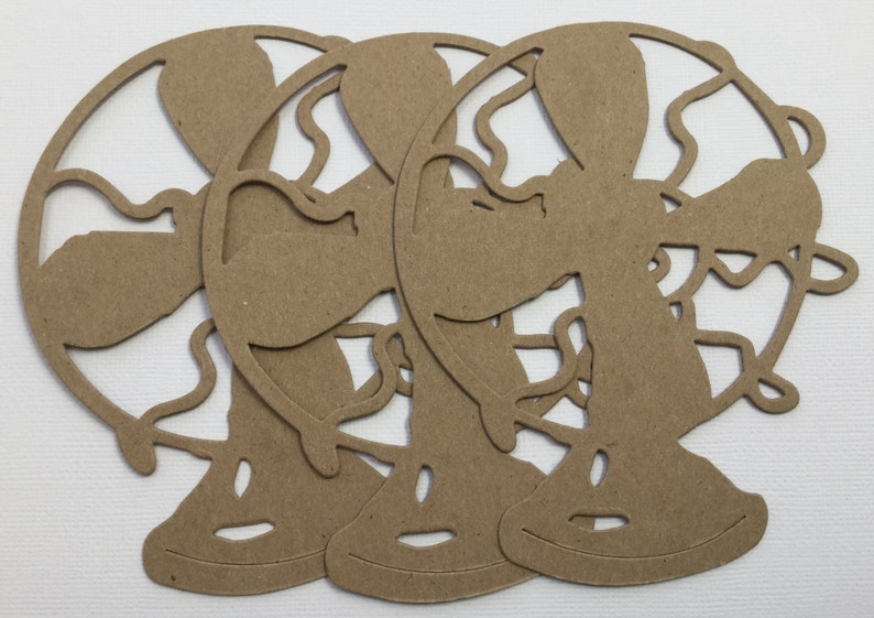 May include: Three brown paper cutouts of globes, each with a detailed outline of the continents and oceans. The globes are stacked on top of each other, with the top globe slightly offset to the right.