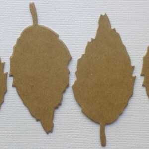 May include: Four brown paper leaves with a jagged edge design. The leaves are cut out and ready to be used for crafting.