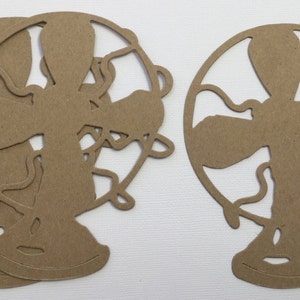 May include: Three brown paper cutouts of vintage fans. The fans have a circular shape with a decorative design and a stand.
